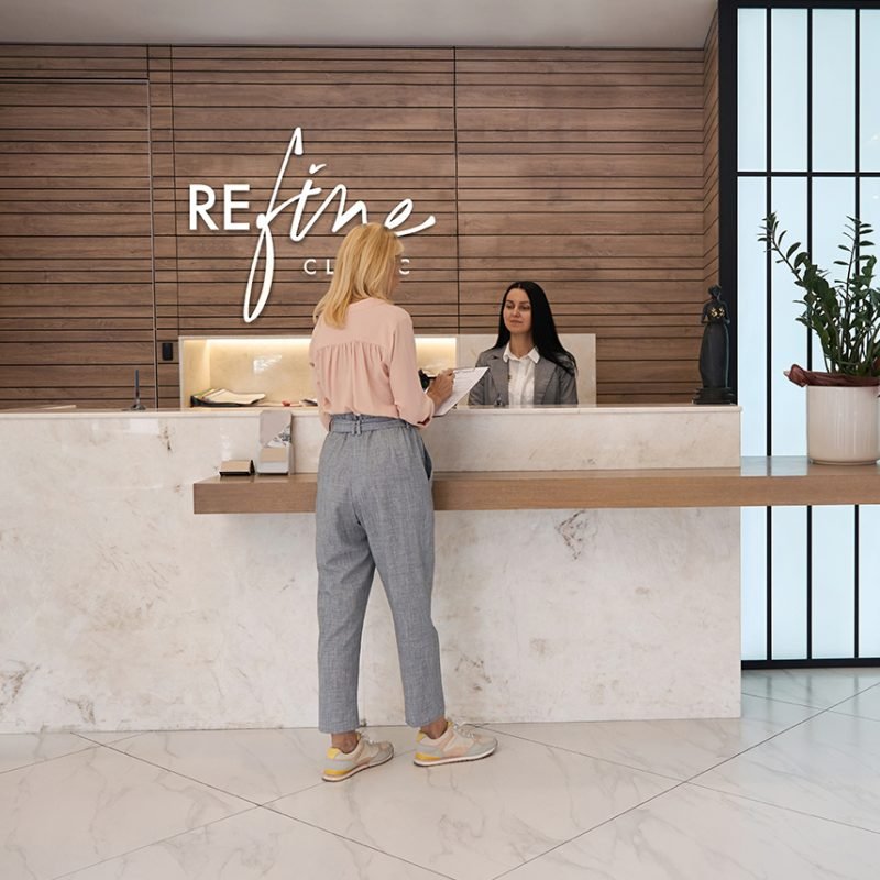 Client,Filling,Up,Form,At,Reception,Desk Client filling up form at reception desk